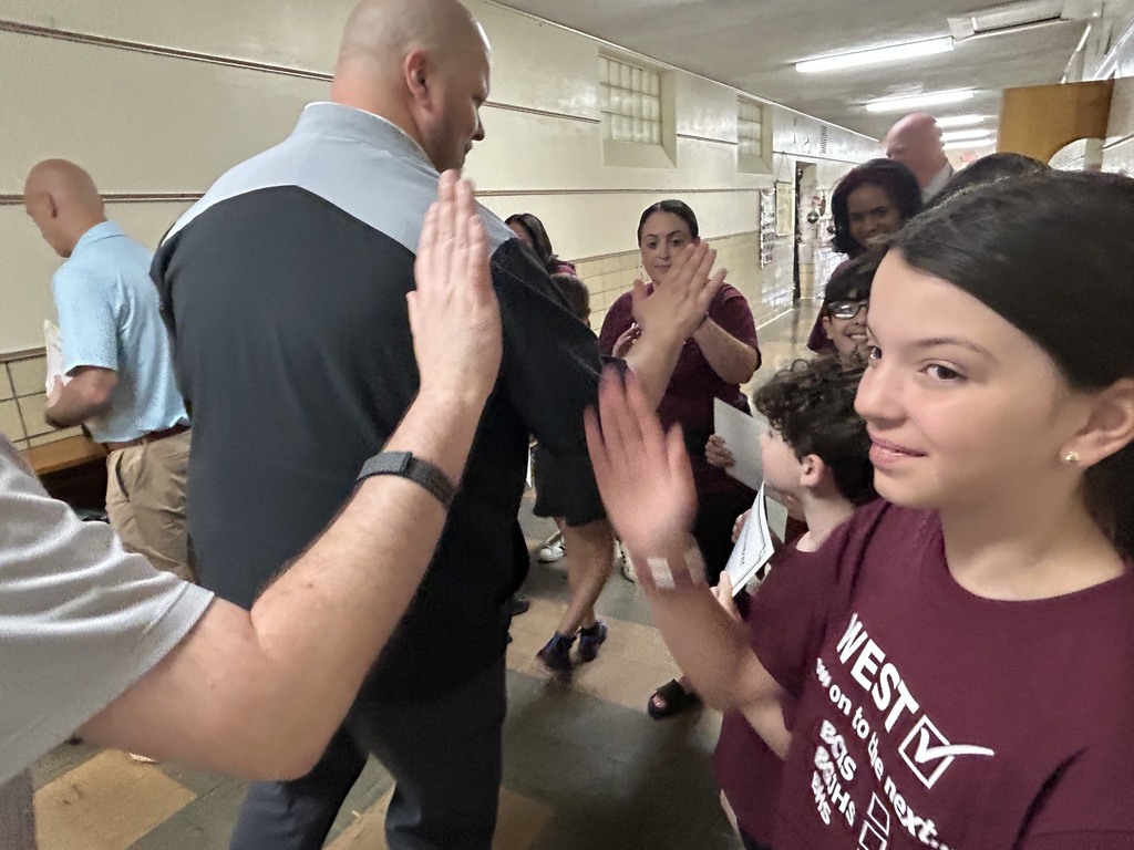 students high fiving with the board