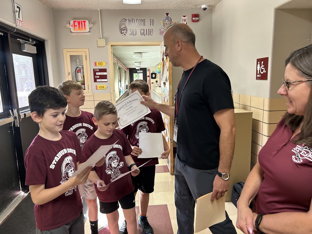 Principal Zoccali handing out perfect score certificates