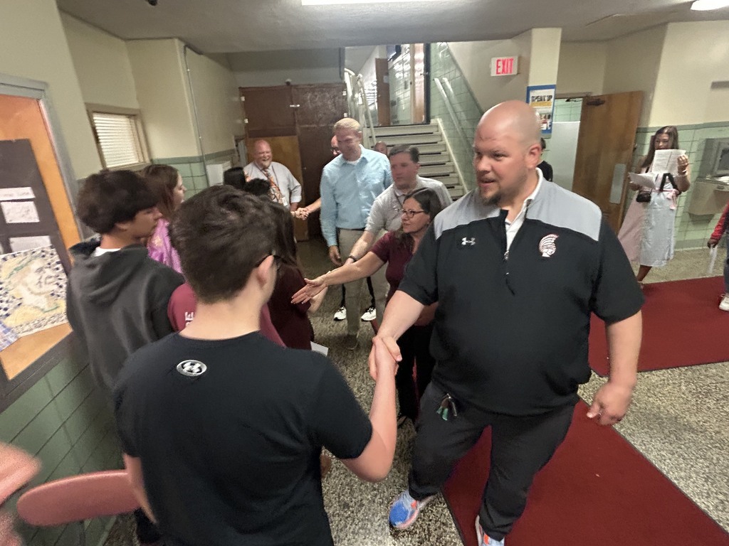 school board members shaking hands with perfect algebra scorers
