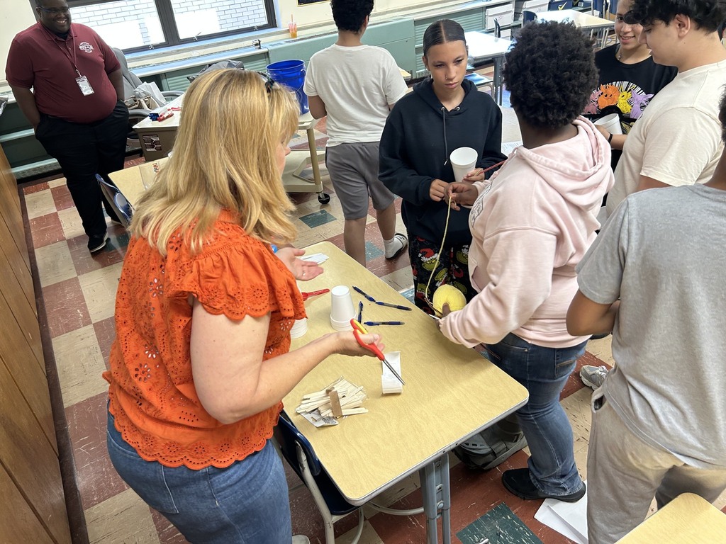 Mrs. Neifer helps students set up for the crystal growing experiment
