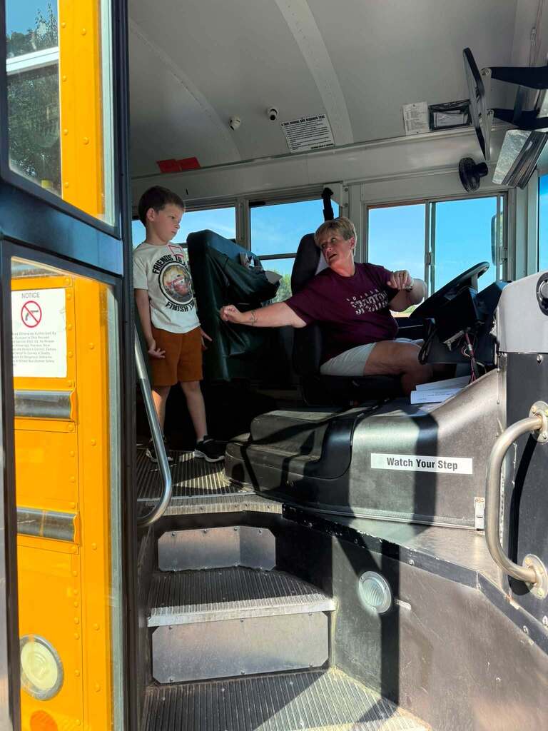 Miss April on her bus with a student