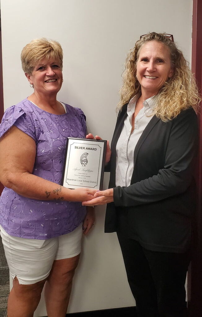 Transportatin supervisor Lisa Bryant giving 25 year award to Miss April SanFilippo