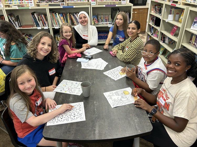 Big and little Spartans around the library table