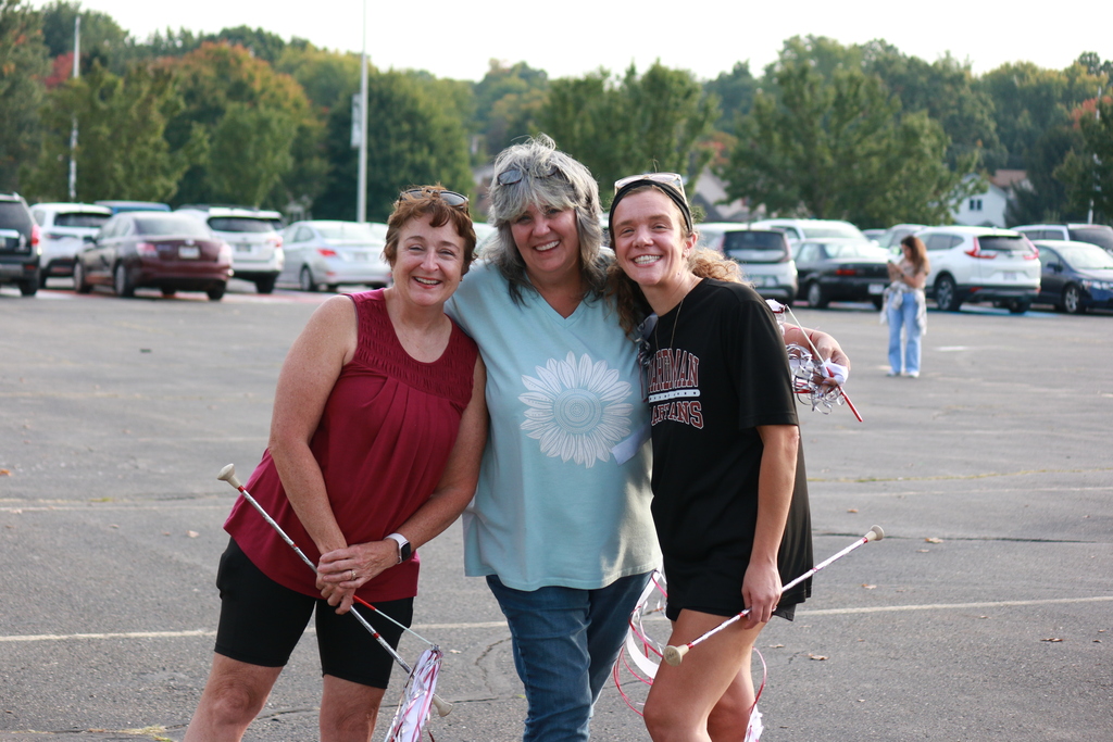 majorette alumni with batons and smiling 