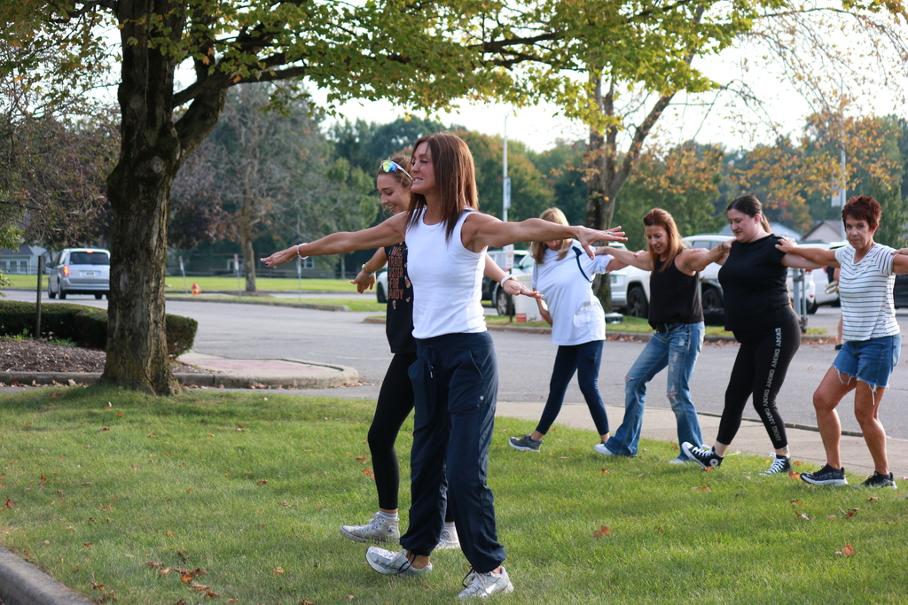 sweetheart advisor dancing in front and running through routine for a group of 10 alumni