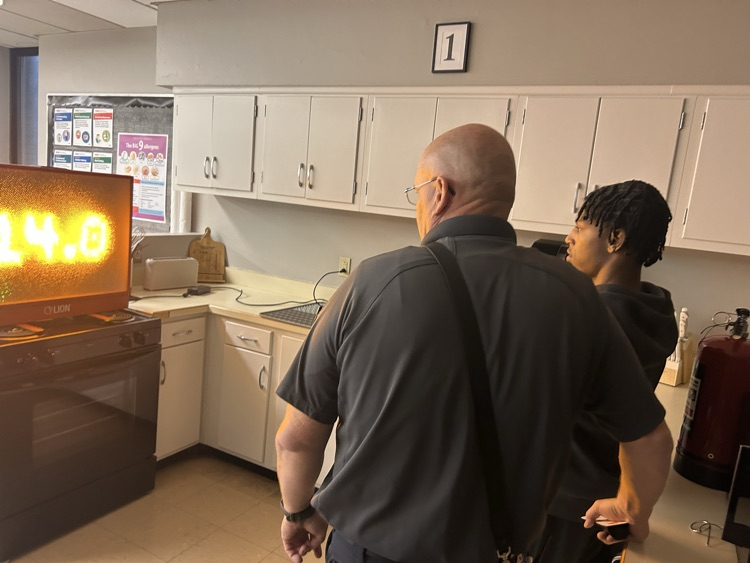 student using electronic fire safety equipment and using extinguisher