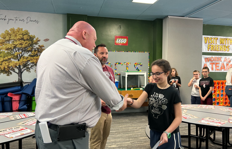 4th grader Anna Hassan accepting certificate from Supt. Neifer
