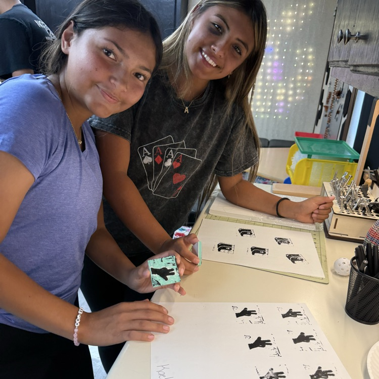 two students pose with their Lino prints 