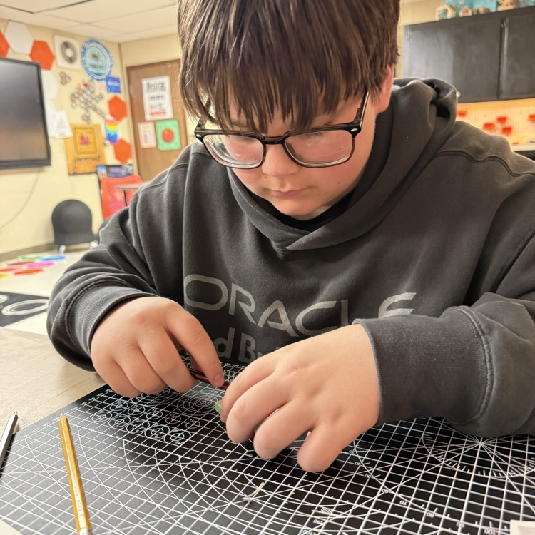student works on a cutting mat