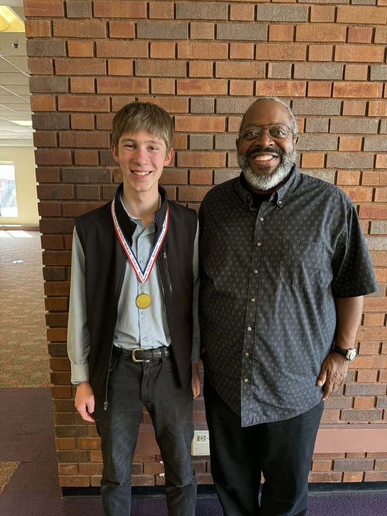 BOLD 8th-grade student, Neil Kadlec,  winner of the Creating Spaces Writing Contest, pictured with Michael Kleber-Diggs, a poet, essayist, literary critic, and arts educator, who was the guest speaker at the event. 
