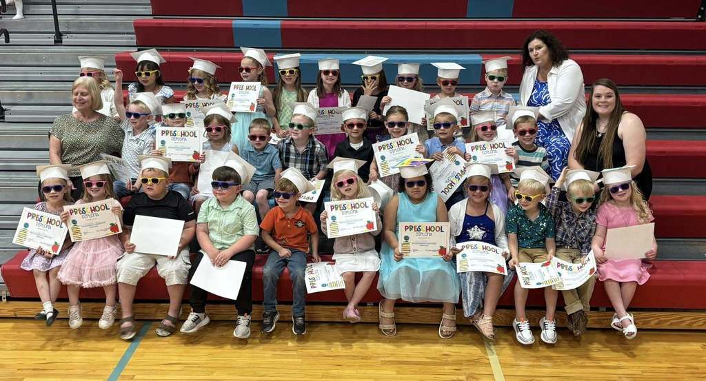 Pre-school kids holding graduation diplomas