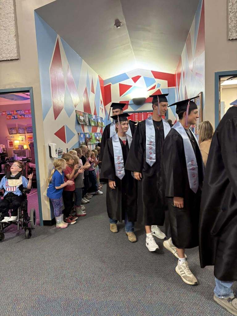 Seniors walking down the hall in graduation robes