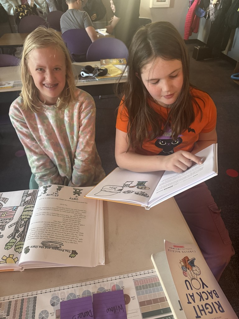 Two students reading their books together.