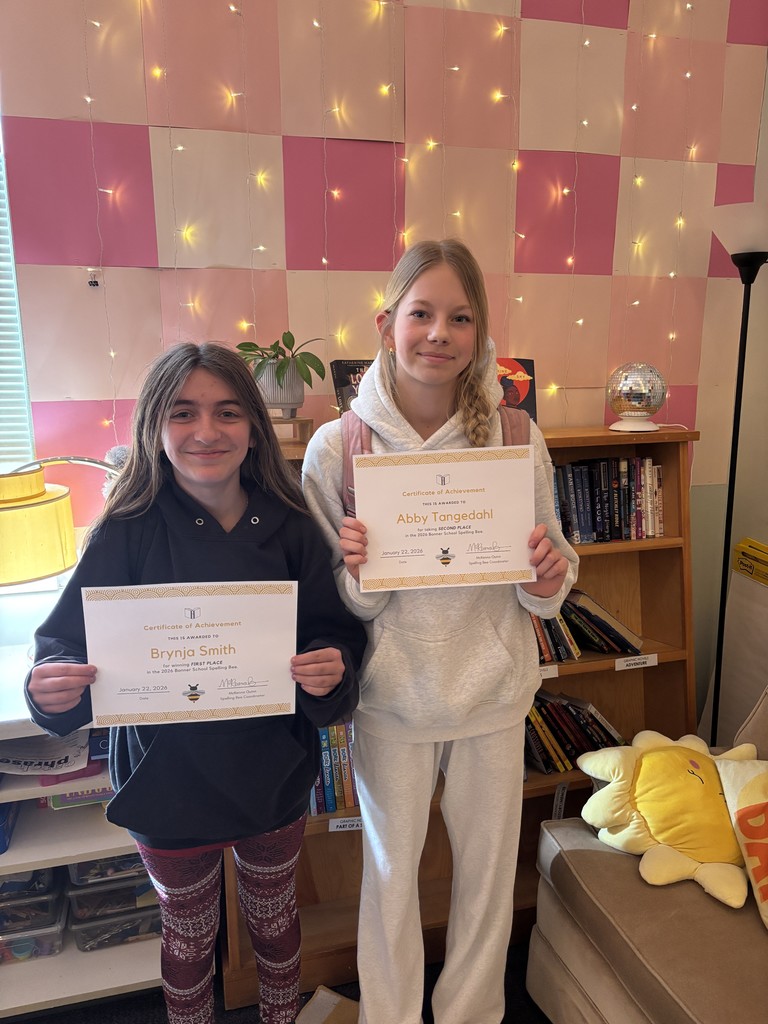 Two spelling bee winners pose for a photo.