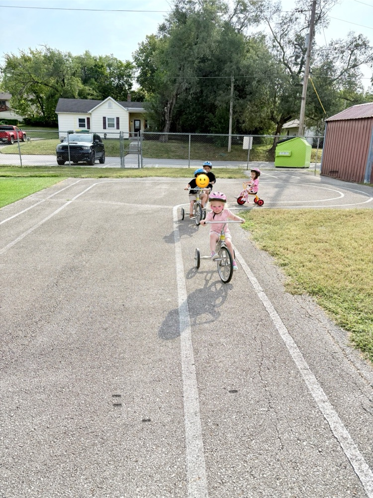 kids riding on tricycles 