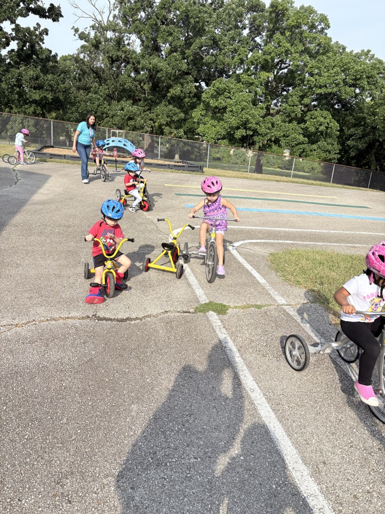 kids riding on tricycles