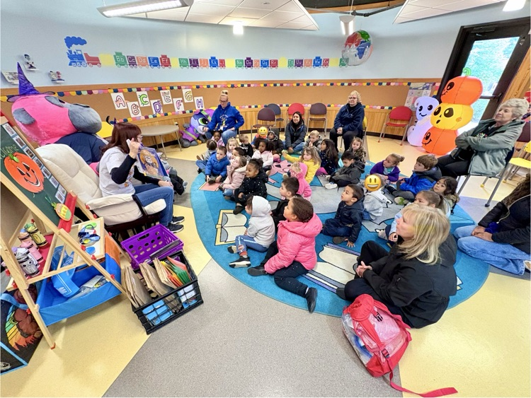 Miss Lesley reads to the kids in the roundhouse