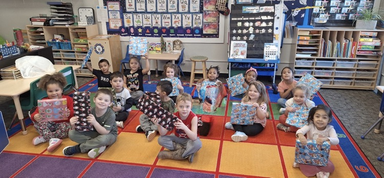 kids hold up unopened gifts