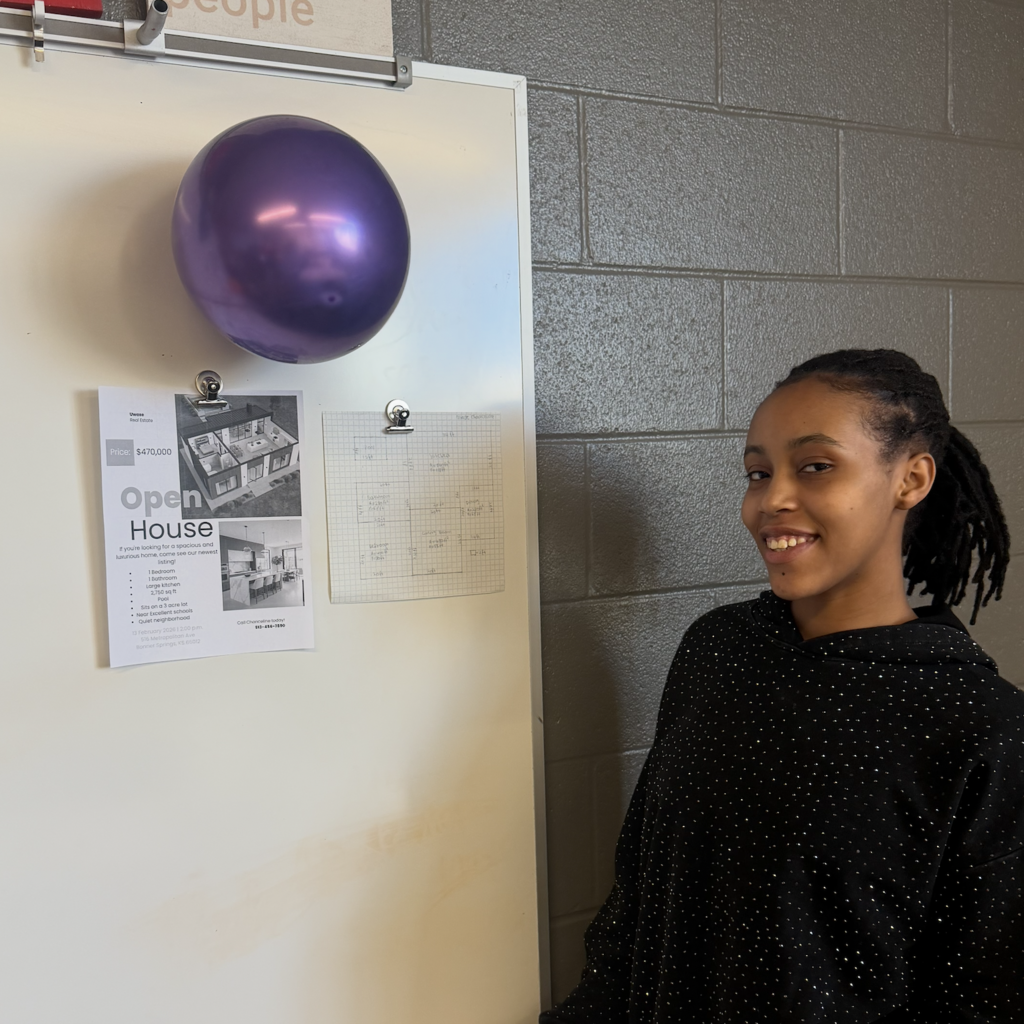 posing with open house flyer