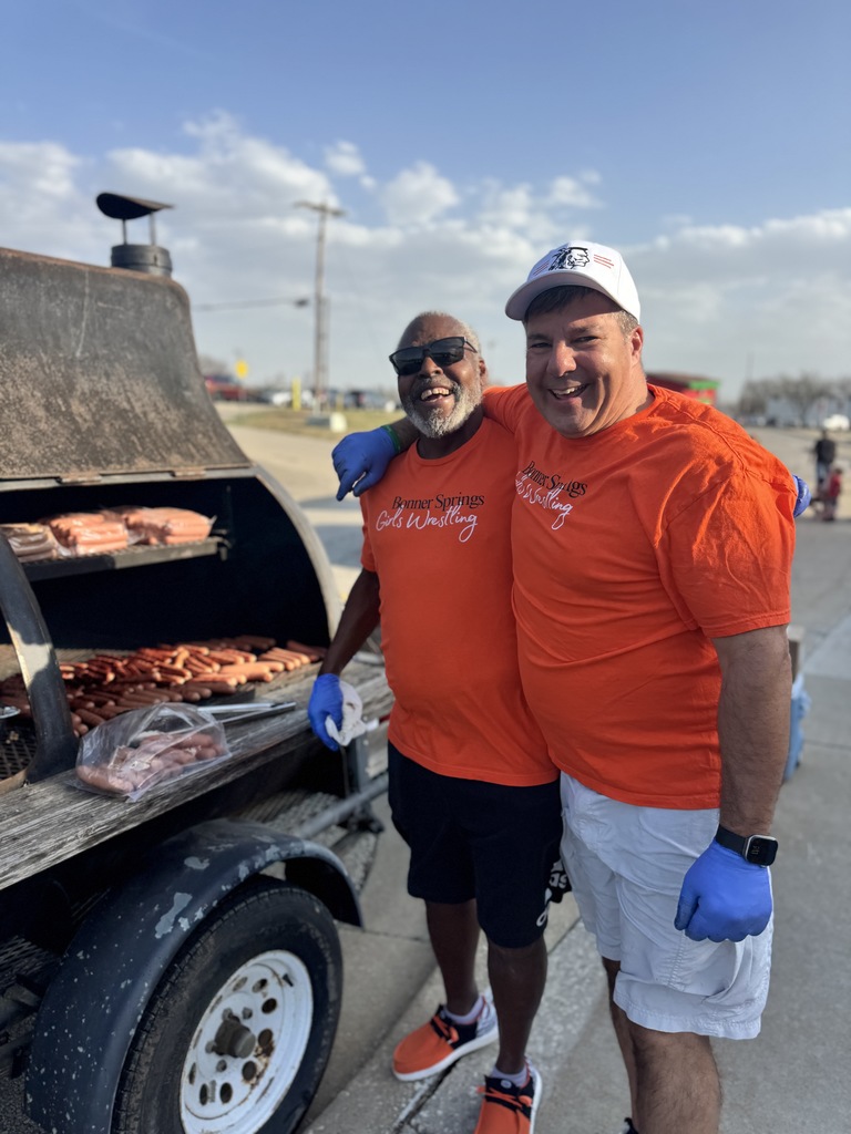 Dale and Paul grilling hotdogs