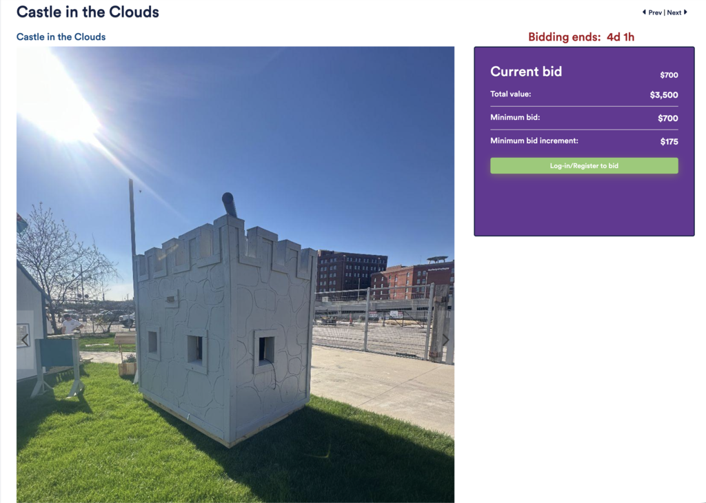 A small white castle on grass with a canon on top. The sun shines brightly. An overlay shows auction details with "Current bid: $700" and a "Bidding ends" countdown.