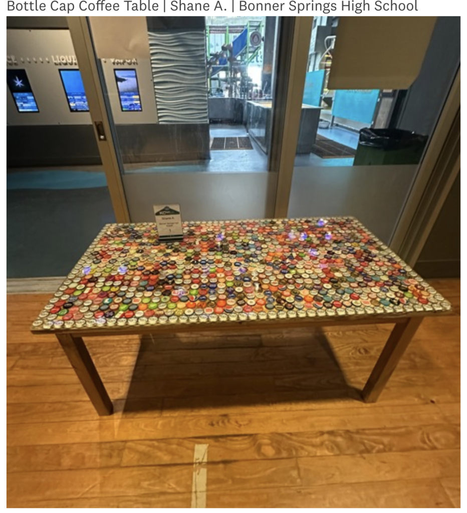 A coffee table with a top made of colorful bottle caps on a wooden floor.