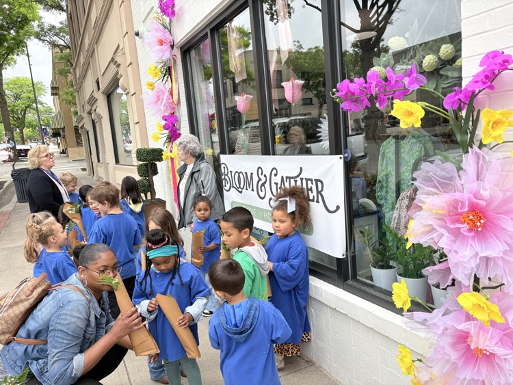 outside the shop, smelling our flowers
