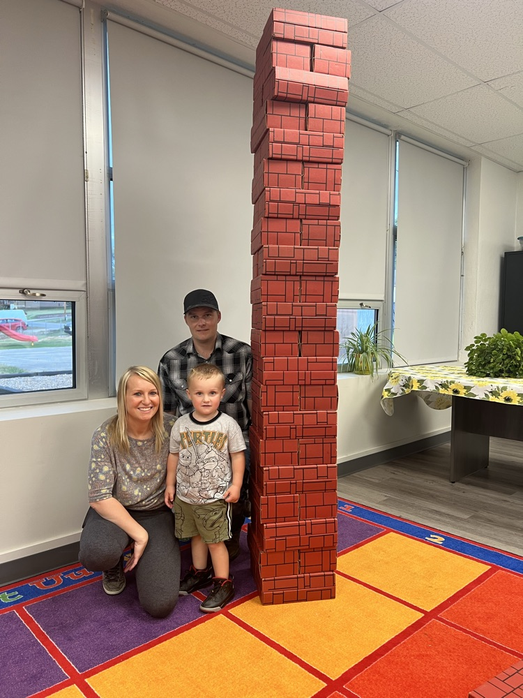 a family shows off how high they built their tower