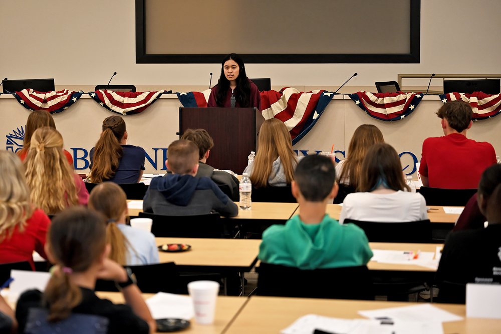 student speaking to other students