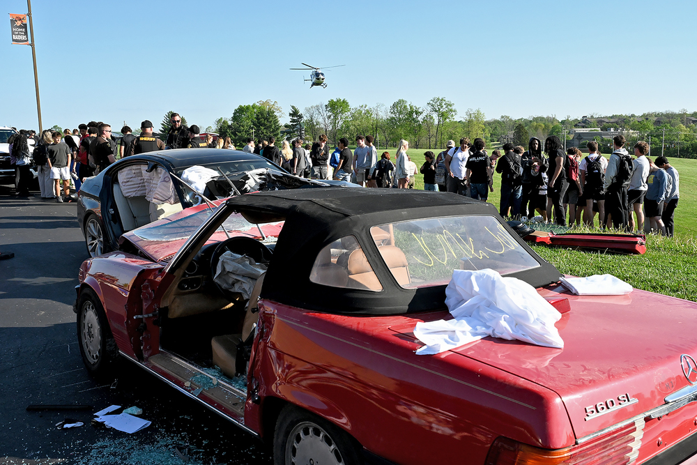 emergency workers and students at simulated car accident