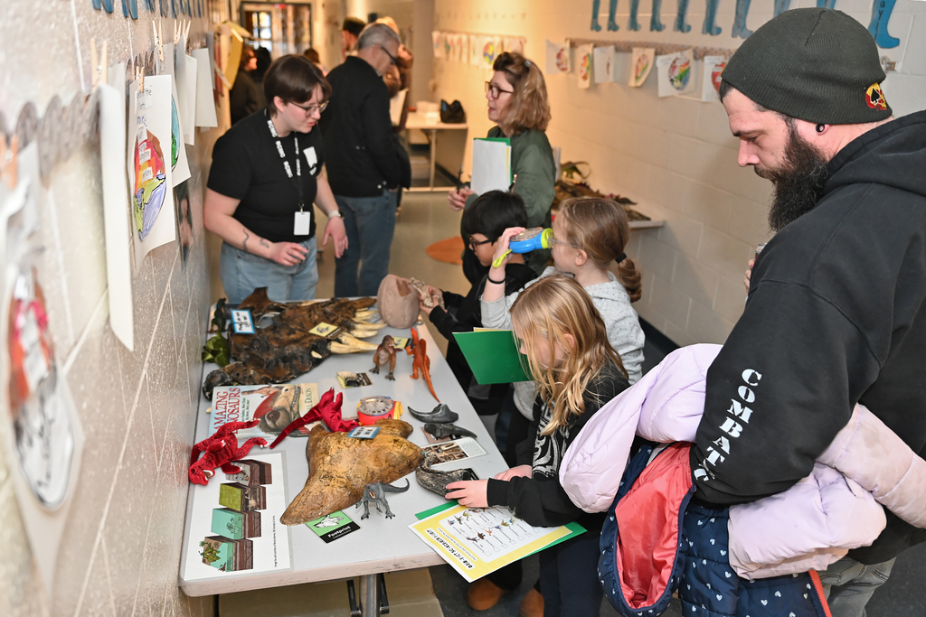 families looking at dinosaur items