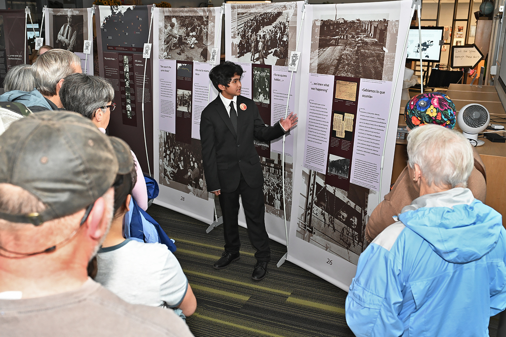 student presnting to community members at Anne Frank exhibit