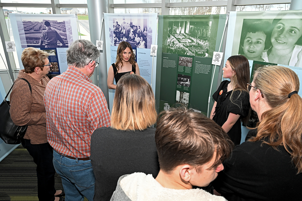 student presnting to community members at Anne Frank exhibit