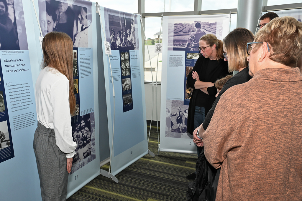 student presnting to community members at Anne Frank exhibit