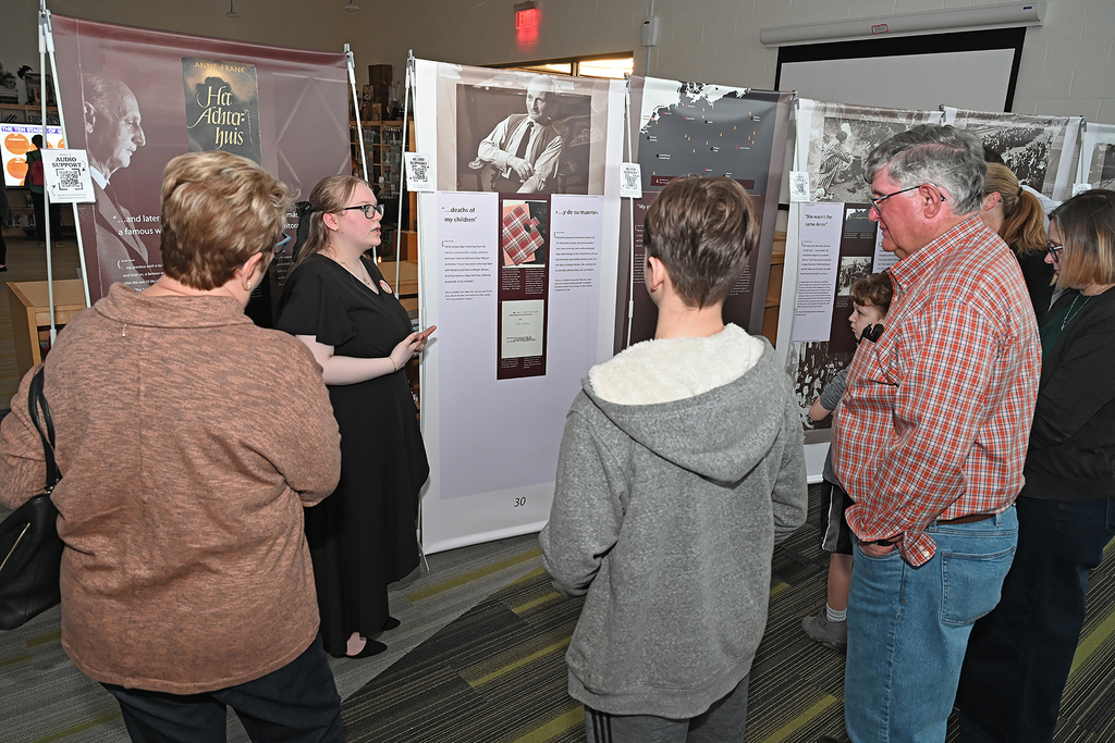 student presnting to community members at Anne Frank exhibit
