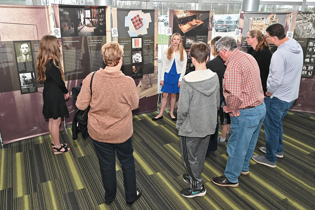 student presnting to community members at Anne Frank exhibit