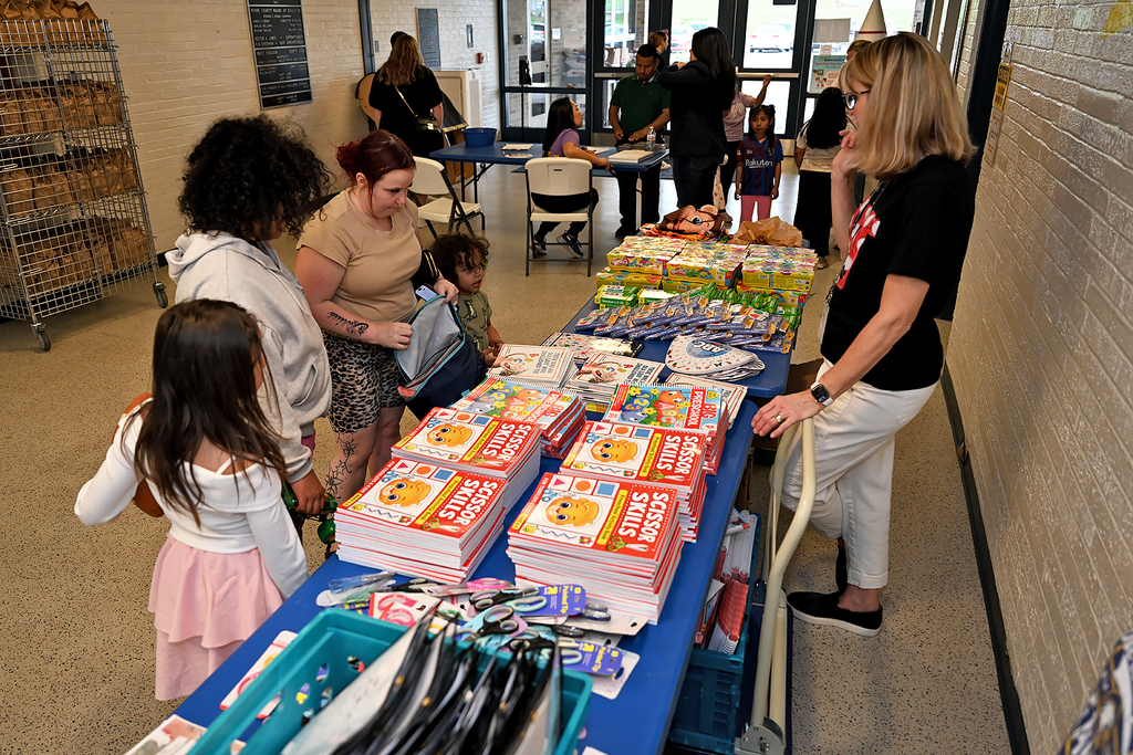 people attending preschool resource fair at a table