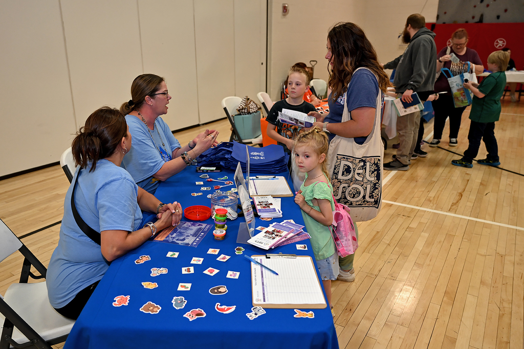 people attending preschool resource fair at a table