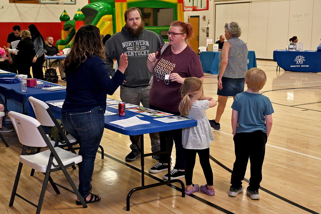 people attending preschool resource fair at a table