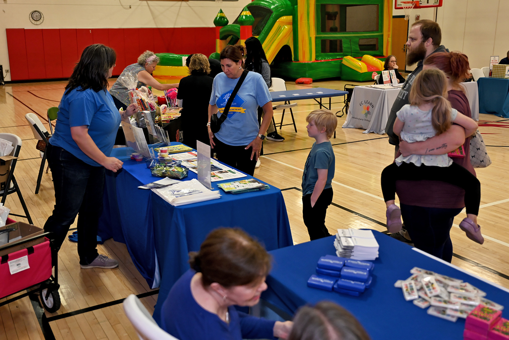 people attending preschool resource fair at a table