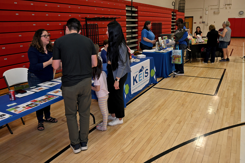 people attending preschool resource fair at a table