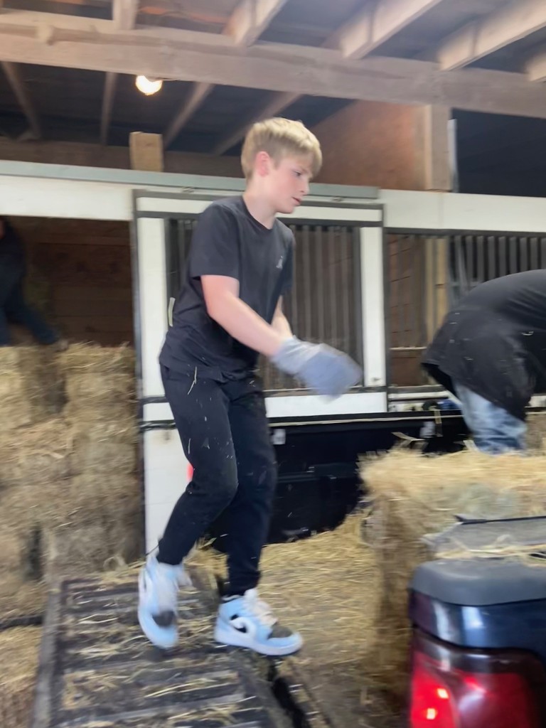 Our 6th graders are tough moving hay!