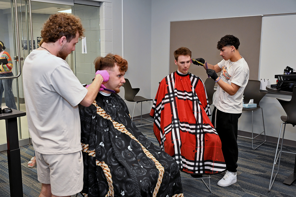 two students getting haircuts