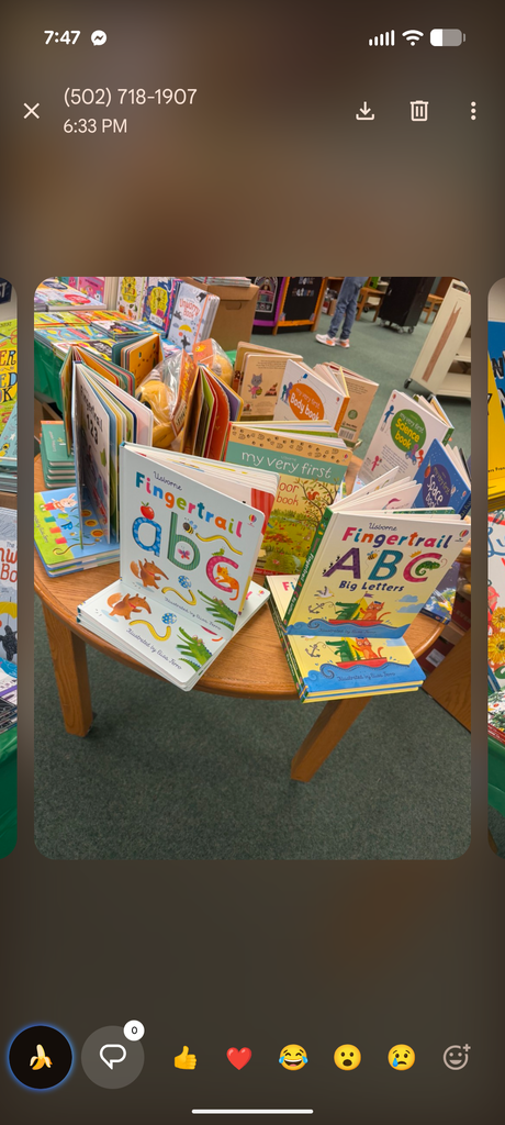 A table with children's books, one titled "Fingertrail abc," arranged on it, captured from a phone screen.