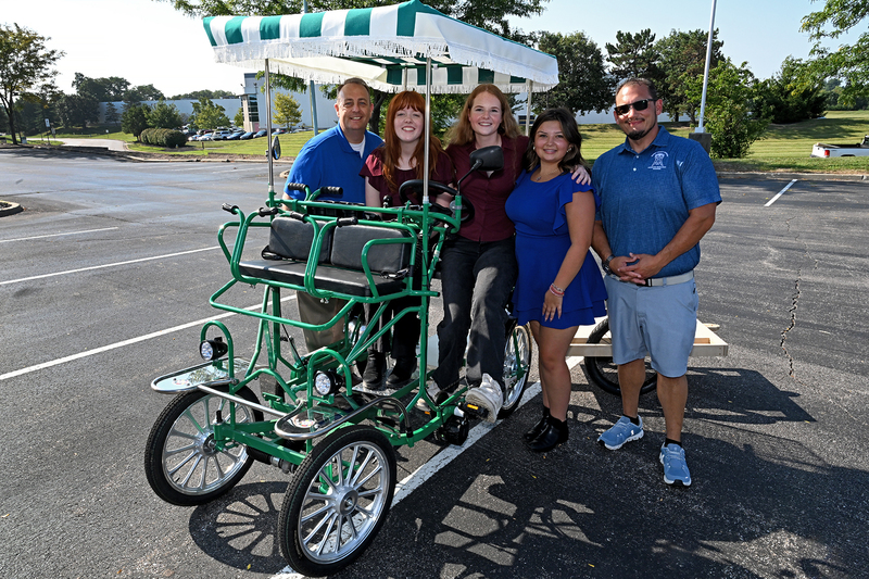 group of people on four wheeled bike