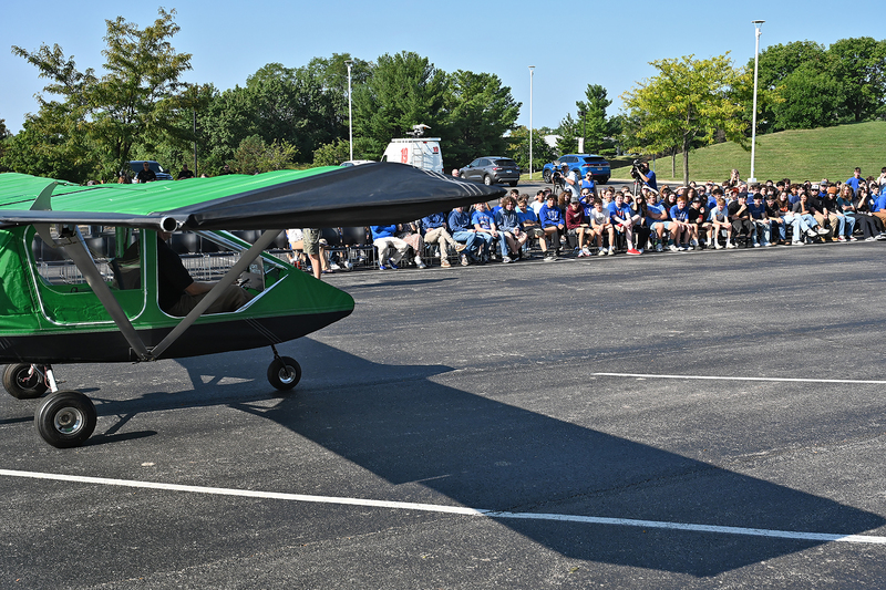 ariplane in front of group of students