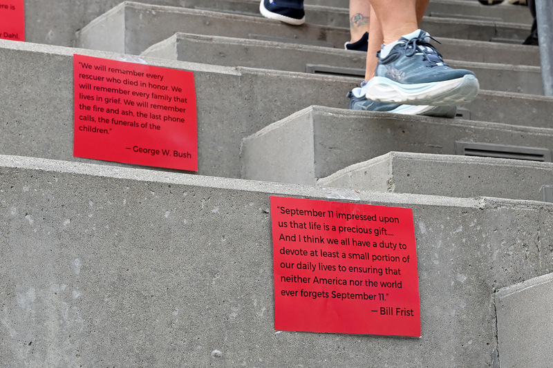 signs on stairs and feet walking by
