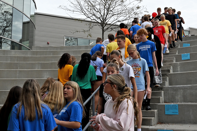 large group of students climbing stairs