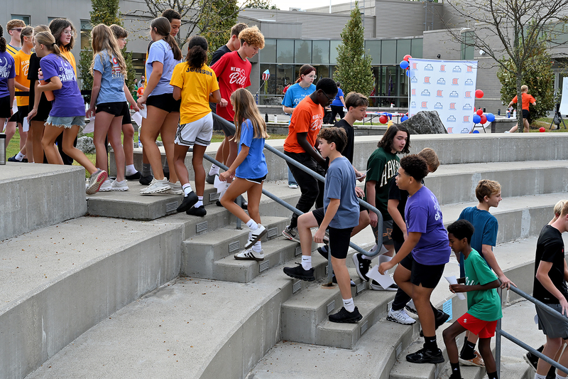 large group of students climbing stairs