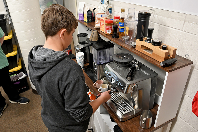 student making coffee